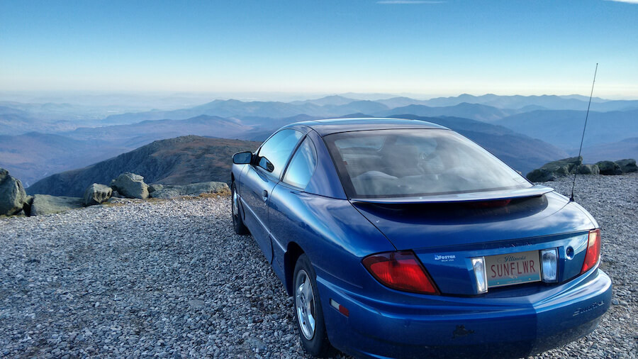 Blue car parked on a mounain overlook